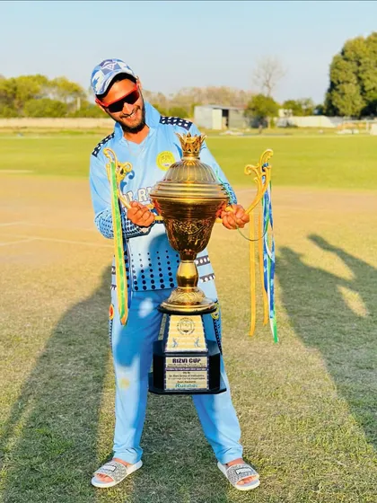 A player celebrating with the Rizvi Cup. The joy of victory is the ultimate reward for the countless hours of hard work on the training ground.