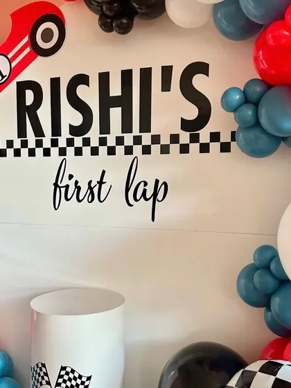 A close-up of the custom backdrop, complete with a vintage racing car and personalized text.