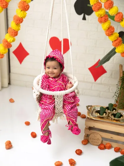 A full view of the Raja Parba setup, complete with a macrame swing, marigold garlands, and festive decorations.