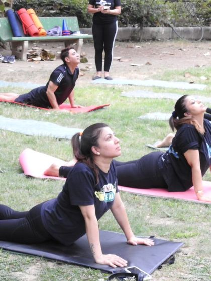 Moving into Bhujangasana (Cobra Pose) under the open sky. This gentle backbend feels even more expansive when practiced in nature.