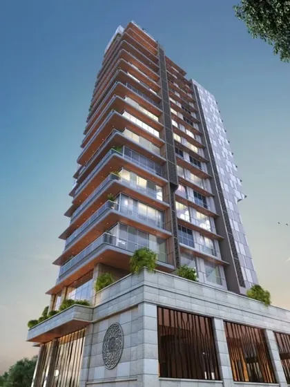An angled view of the Elysia tower, highlighting the texture of the stone cladding on the lower levels. This detail adds a sense of permanence and sophistication to the modern glass structure.