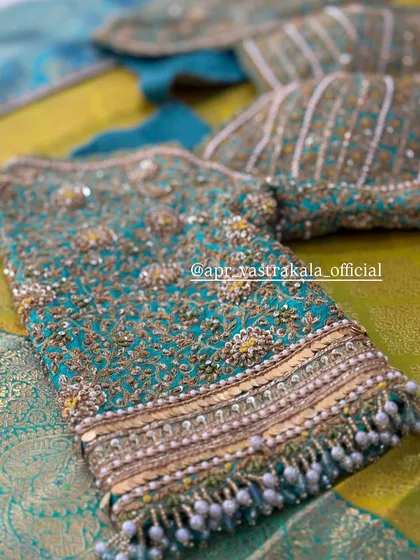 The beauty is in the details. This teal bridal blouse showcases dense zardosi and pearl beadwork, creating a rich, textured look that feels incredibly luxurious.