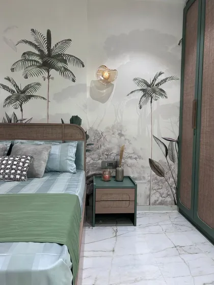 A closer look at the nature-themed bedroom, highlighting the texture of the rattan headboard and the detailed mural. The simple, elegant wall sconce provides a soft glow, perfect for evening relaxation.