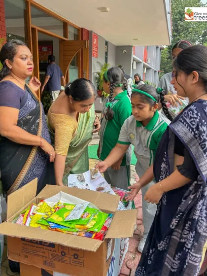 Teachers and students sort through the collected materials. This is a great example of a school community coming together to make a tangible environmental impact.