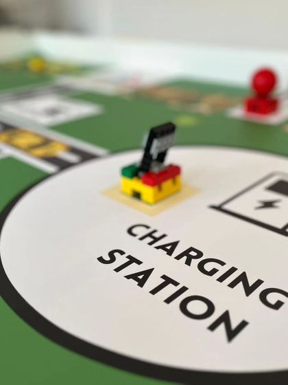 A close-up of the "Charging Station" on the IRO Innovators mat. This element introduces the concept of power management into the robotics challenge.
