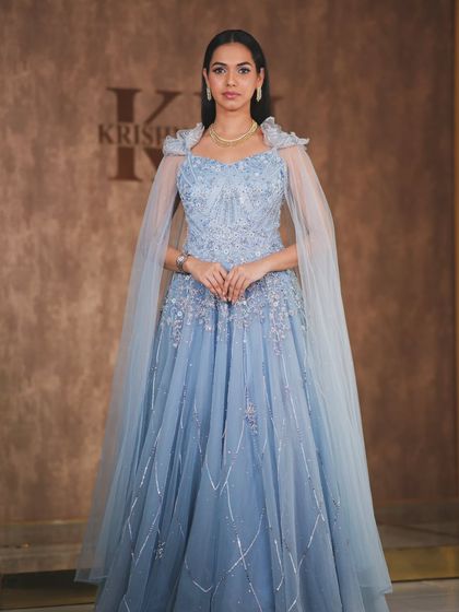 A modern, fashion-forward look featuring a pearl-encrusted gown. The simple diamond drop earrings are the perfect accessory for this statement outfit.