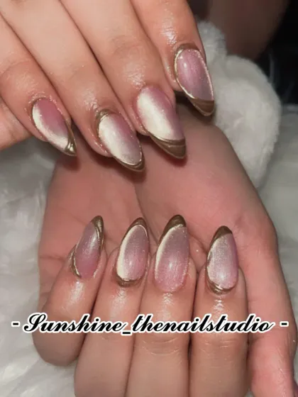 A close-up of the cat eye nails with a gold chrome French tip.