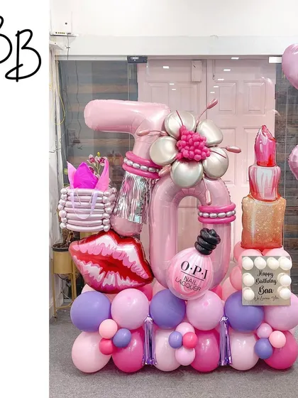 Kisses and wishes for a beauty enthusiast! This makeup-themed arrangement for a 16th birthday is packed with details, including a sculpted lipstick, nail polish bottle, and a shopping bag.