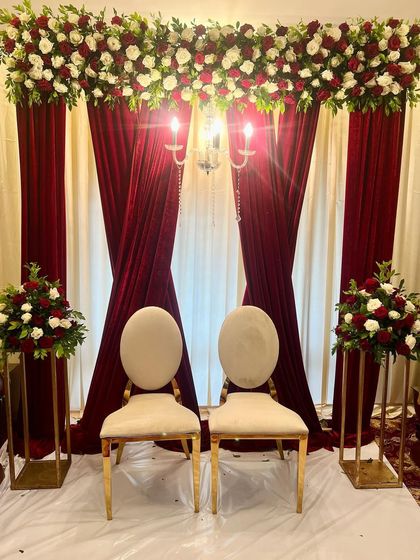 A classic and elegant setup for an intimate Baat Pakki ceremony. We used rich red velvet curtains and beautiful floral arrangements to create a timeless and sophisticated backdrop.