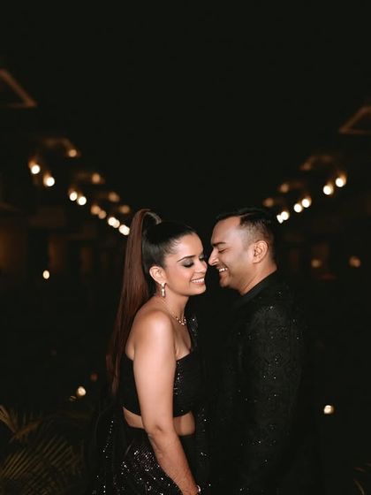 A classic, romantic portrait of the couple at their cocktail event, with the groom looking lovingly at his bride.