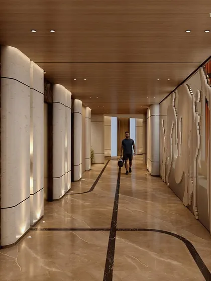 The corridor of the sports club, featuring marble floors and artistic wall panels. The design creates a sophisticated and motivating environment, leading to the various state-of-the-art facilities.