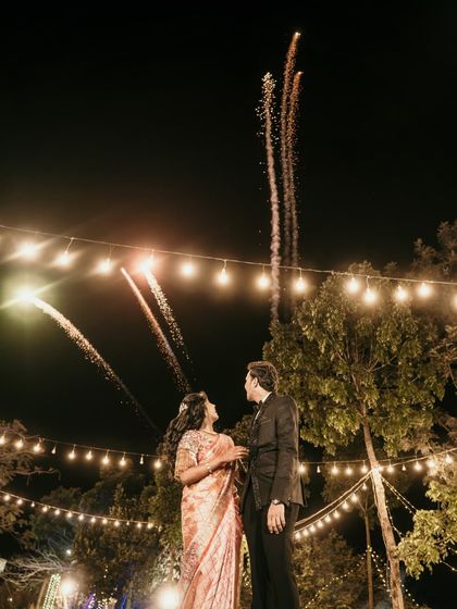 The couple watching fireworks at their reception, a perfect end to a magical evening.