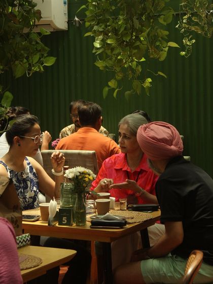 Guests engaged in conversation during a pop-up event. My goal is to create a convivial atmosphere where the food sparks connection and creates lasting memories.