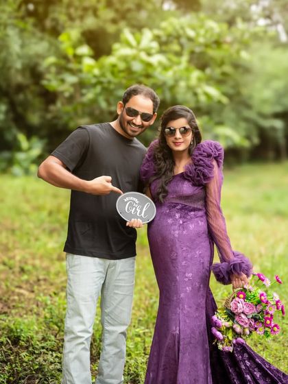 A fun "It's a Girl!" announcement photo. The couple's playful pose and sunglasses add a cool, modern vibe to their outdoor maternity session.
