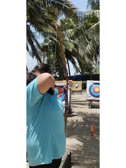 A student takes her shot, demonstrating the strength and technique learned in our beginner course.