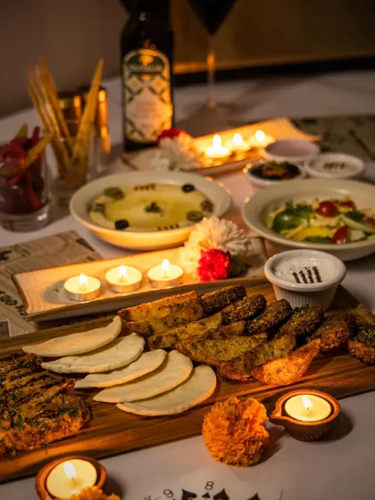 A candlelit dinner setup featuring our Lebanese platter. We help create the perfect ambiance for your special occasions, where the food is as beautiful as the decor.