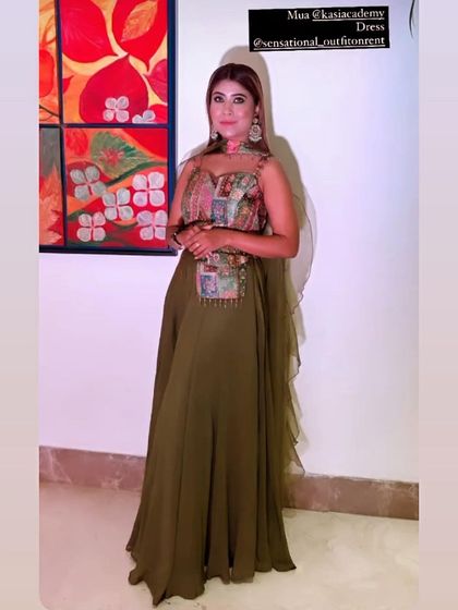 An elegant olive green gown with a uniquely embellished bodice. This indo-western rental piece is perfect for someone who wants a contemporary and stylish look.
