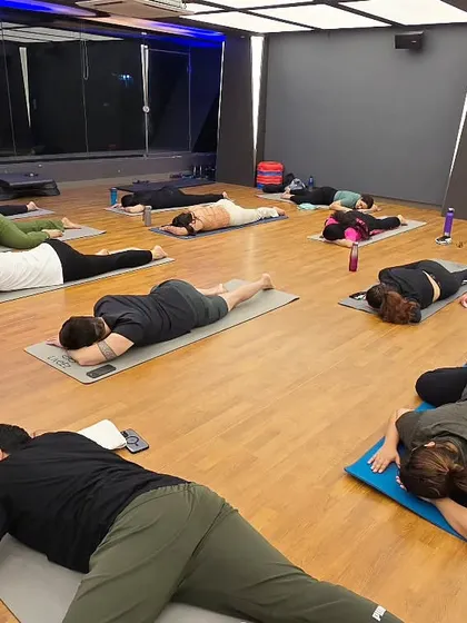 Students in Shithil Asana, the relaxing pose. This asana provides deep relaxation to the entire body, relieving fatigue and tension.