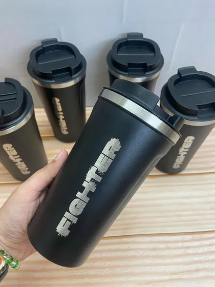 A closer look at the 'Fighter' branded coffee flask, a practical and stylish piece of merchandise.