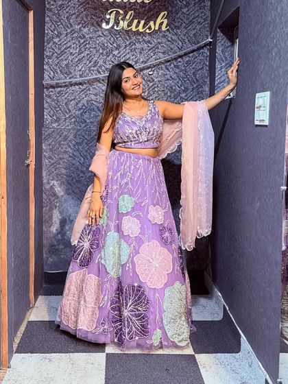 A full-length shot of the lavender floral lehenga. It's a great example of the stylish and modern non-bridal outfits I have for rent.
