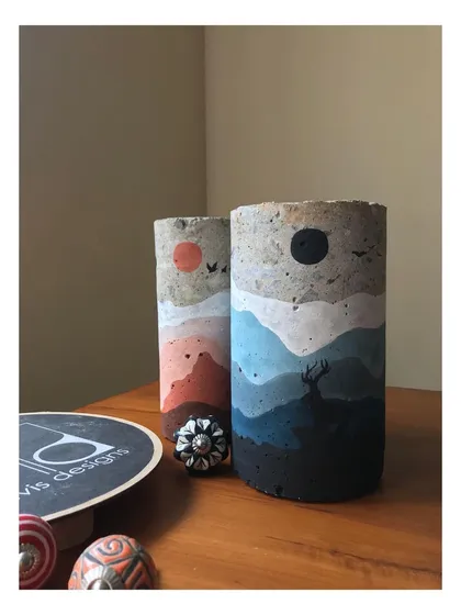 This image showcases two of my 'Mystic Mountains' sculptures side by side. I transform discarded concrete core cuts from construction sites into unique art objects, each hand-painted with a different landscape. It is my way of giving waste a new, beautiful life.
