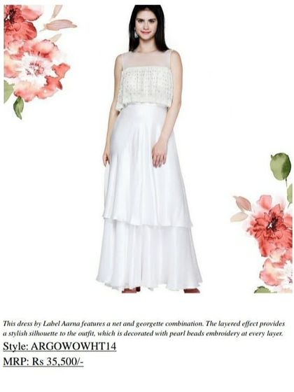 This AARNA dress features a net and georgette combination with a layered effect and pearl bead embroidery. This stylish silhouette, originally priced at Rs 35,500, is now available at a significant discount.