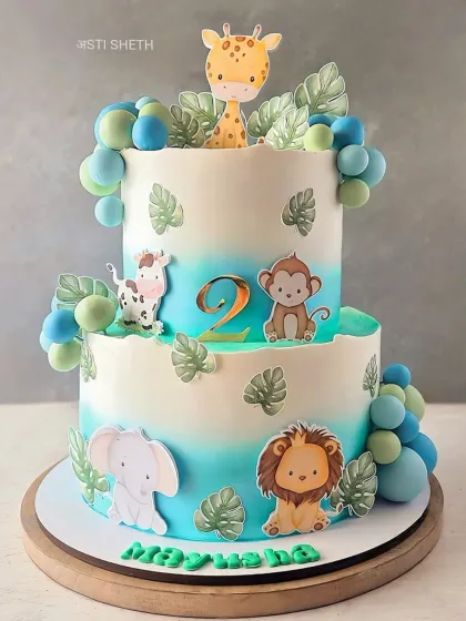 A two-tiered jungle safari cake perfect for a little one's birthday. This 4kg creation combines fresh strawberry and chocolate flavours, all covered in my signature non-fondant whipped cream. The gentle blue ombre, cute animal toppers, and handcrafted leaves bring the friendly jungle theme to life.