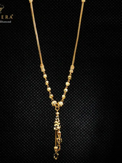 This lightweight gold mangalsutra-style chain features a decorative pendant with dangling elements. It offers a modern take on a traditional piece, designed for comfort and style.