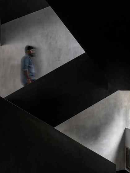 The dynamic angles of the Brick House staircase create a sense of movement and energy within the home.