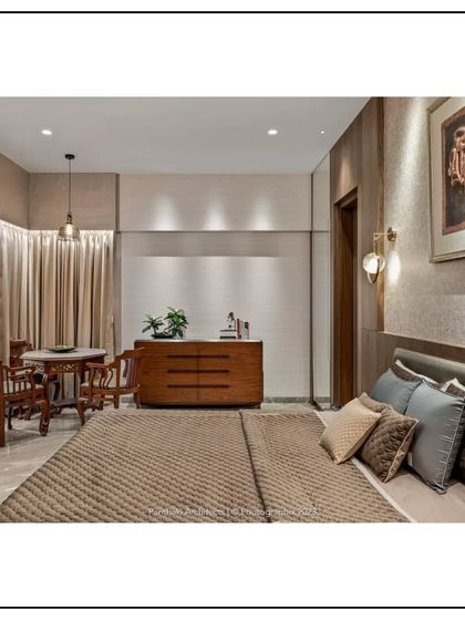 This spacious bedroom includes a small, intimate seating area by the window, perfect for a morning coffee or quiet reflection. The design maximizes both comfort and functionality within a single personal space.