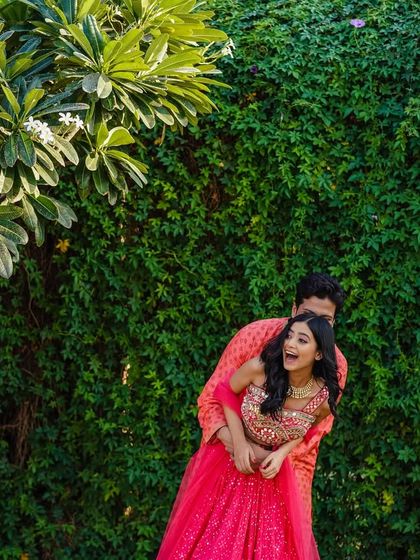 A playful lift and a burst of laughter. This shot is all about capturing the fun and carefree spirit of the couple during their outdoor shoot.