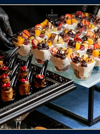 A sweet ending is essential. I offer a variety of single-serving desserts, like these fruit and cream trifles, elegantly presented in individual cups for easy enjoyment by your guests.