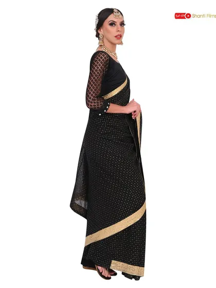 A side-profile view of the black and gold saree, focusing on the silhouette and the detailed border. We provide multiple angles to give customers a comprehensive understanding of the product.