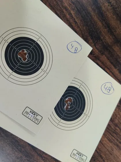 A close-up of Krish's targets, both showing a score of 48/50. We analyze these cards to identify areas for technical improvement.