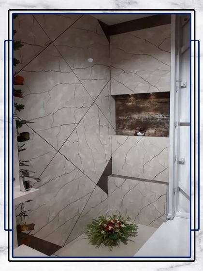 A sanctuary of luxury in every detail. This bathroom uses a unique tile pattern and a touch of greenery to create a space that feels both opulent and tranquil.