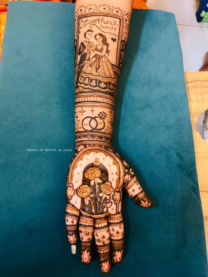 Your mehendi can tell your story. For this bride, I created a full arm piece with a custom portrait of the couple, their engagement rings, and beautiful rose motifs to celebrate their journey.
