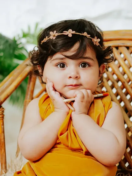 A sweet, thoughtful portrait. Her gentle expression and the soft, natural light create a beautiful and timeless image.