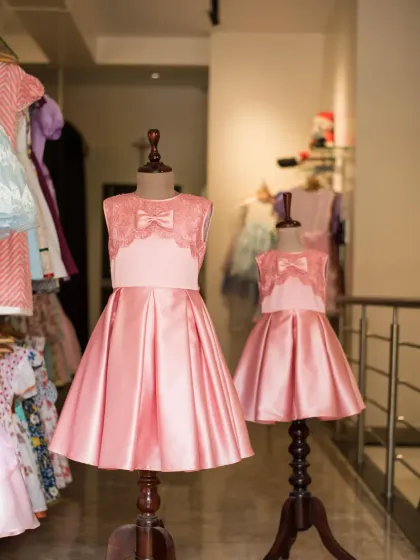 A view of the matching pink satin dresses from my studio. Creating identical pieces in different sizes is one of my favorite ways to help sisters celebrate their connection.