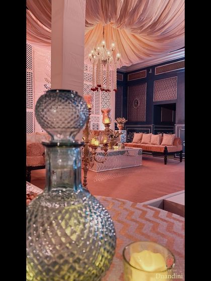 For a traditional sangeet, we styled the bistro tables with beautiful glass 'ittar' (perfume) bottles instead of florals, adding a unique and fragrant touch to the decor.