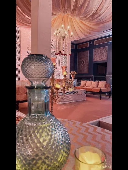 For a traditional sangeet, we styled the bistro tables with beautiful glass 'ittar' (perfume) bottles instead of florals, adding a unique and fragrant touch to the decor.