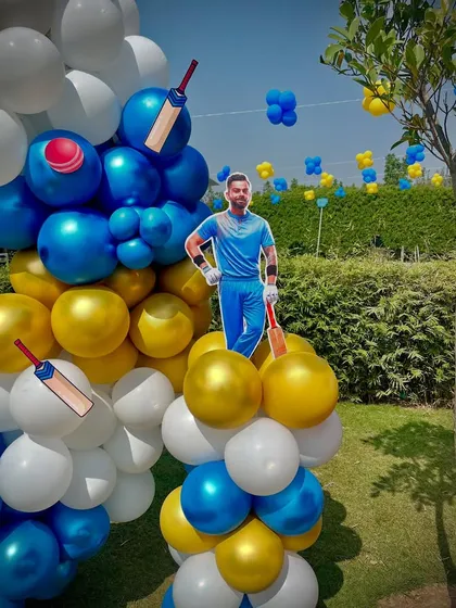 A close-up of the balloon arch with cutouts of a cricketer and cricket bats, showing the attention to detail in my themed parties.
