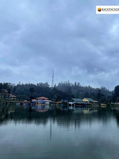The serene Kodaikanal lake on a cloudy day, perfect for a peaceful boat ride.