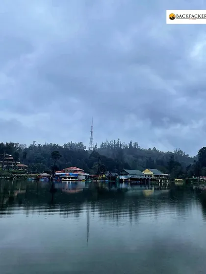 The serene Kodaikanal lake on a cloudy day, perfect for a peaceful boat ride.