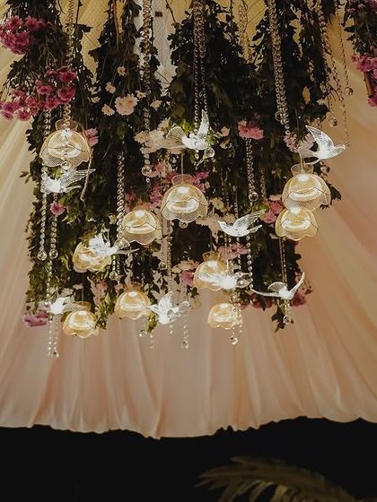 Another angle of the beautiful ceiling decor. The combination of flowers, hanging crystals, and soft draping fabric transforms the entire space into a fairytale setting.