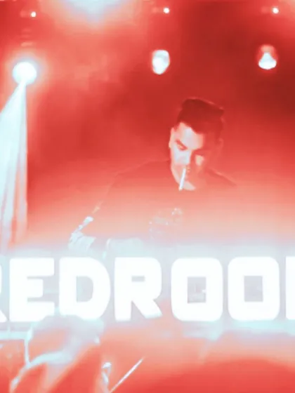 In front of the iconic Redroom sign. These nights are always about high-energy techno and a crowd that's ready to dance.