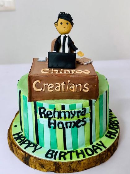 A cake for the hardworking significant other! This design features a custom topper of the birthday boy at his desk, representing his own company. A perfect cake for the hustler in your life.