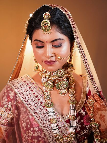A moment of quiet grace. This shot captures the intricate details of the jewellery and the soft, blended eye makeup.