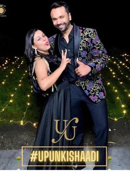 Fun and fabulous! A couple strikes a pose at their gala dinner, showing off their amazing floral jacket.