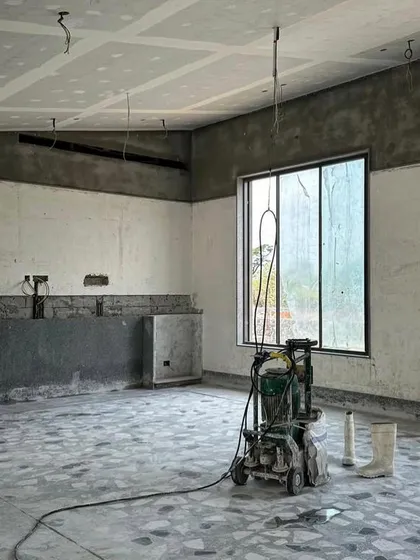 The interior of an Alibaug house during the finishing stages. A floor polishing machine sits in the middle of the room, ready to bring out the beauty of the terrazzo flooring.