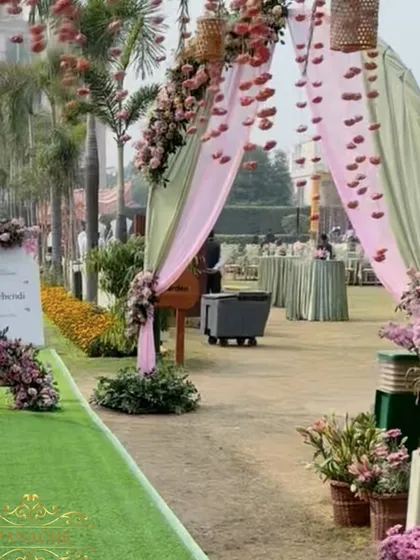 The entrance walkway leading into the main event area, with a welcome sign and floral arrangements.